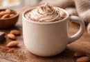 creamy almond milk hot chocolate in a ceramic mug with cocoa topping
