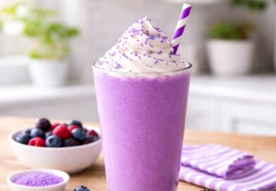 purple smoothie topped with whipped cream and fresh berries, featured in the Grimace Shake Recipe.