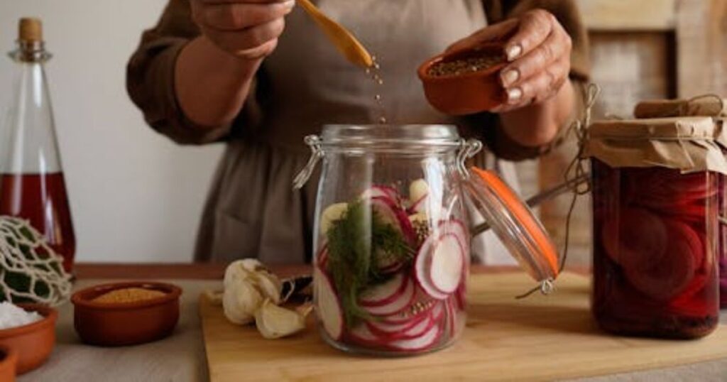 How to Make Pickle Juice for Cramps,
prepares pickles by pouring brine into a jar, demonstrating how to make pickle juice at home.