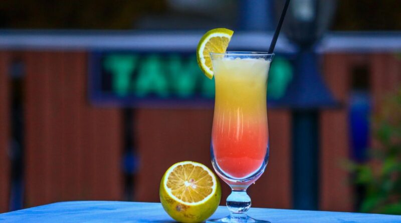 A vibrant cocktail garnished with a lime slice, representing the Lemon Drop Cutwater recipe.