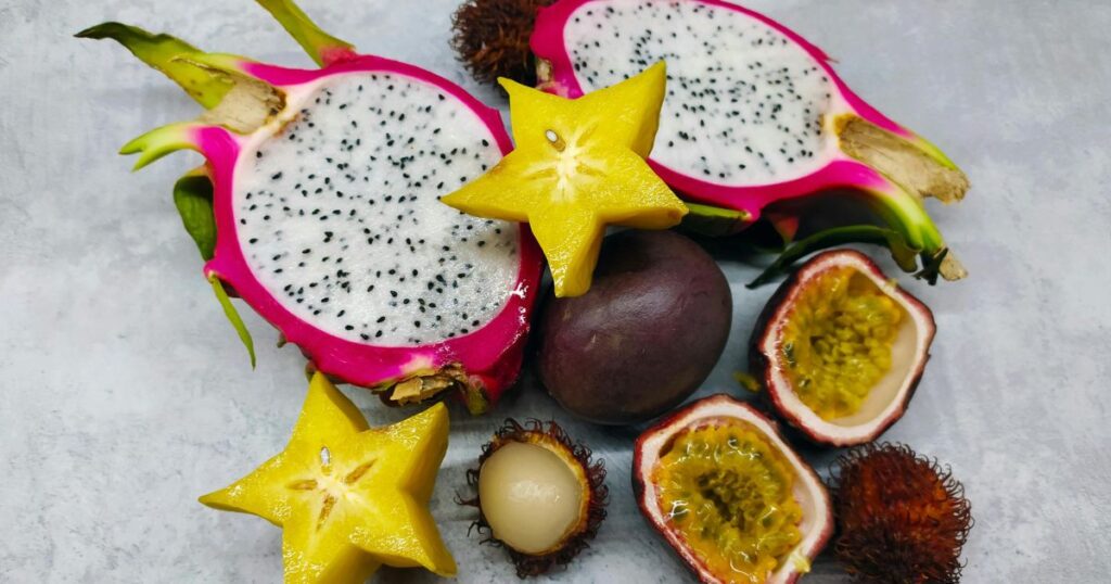 A visual comparison of dragon fruit types: white, red, and yellow, arranged neatly on a table.