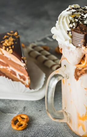 A rich chocolate milkshake adorned with pretzels and chocolate, named 'Death by Chocolate Shake.