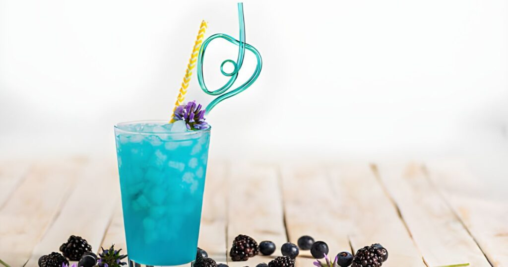 sonic ocean water garnished with blackberries and lavender, placed on a rustic wooden table.