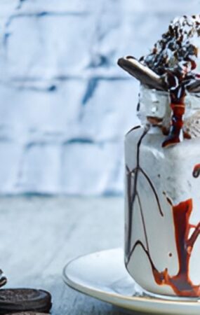 Oreo milkshake topped with chocolate drizzle and whipped cream, inspired by Chick-fil-A's creamy recipe.